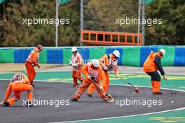 Marshals clear debris from the circuit after the start of the race. 31.07.2022. Formula 1 World Championship, Rd 13, Hungarian Grand Prix, Budapest, Hungary, Race Day.