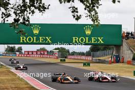 Daniel Ricciardo (AUS) McLaren MCL36 and Kevin Magnussen (DEN) Haas VF-22 battle for position. 31.07.2022. Formula 1 World Championship, Rd 13, Hungarian Grand Prix, Budapest, Hungary, Race Day.