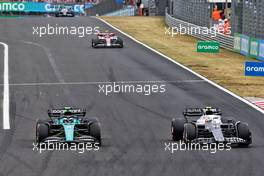 (L to R): Sebastian Vettel (GER) Aston Martin F1 Team AMR22 and Yuki Tsunoda (JPN) AlphaTauri AT03 battle for position. 31.07.2022. Formula 1 World Championship, Rd 13, Hungarian Grand Prix, Budapest, Hungary, Race Day.