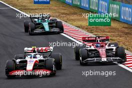 (L to R): Mick Schumacher (GER) Haas VF-22 and Valtteri Bottas (FIN) Alfa Romeo F1 Team C42 battle for position. 31.07.2022. Formula 1 World Championship, Rd 13, Hungarian Grand Prix, Budapest, Hungary, Race Day.