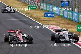 (L to R): Guanyu Zhou (CHN) Alfa Romeo F1 Team C42 and Yuki Tsunoda (JPN) AlphaTauri AT03 battle for position. 31.07.2022. Formula 1 World Championship, Rd 13, Hungarian Grand Prix, Budapest, Hungary, Race Day.