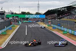 Sergio Perez (MEX) Red Bull Racing RB18 and Esteban Ocon (FRA) Alpine F1 Team A522 battle for position. 31.07.2022. Formula 1 World Championship, Rd 13, Hungarian Grand Prix, Budapest, Hungary, Race Day.