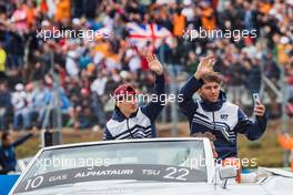 (L to R): Yuki Tsunoda (JPN) AlphaTauri and team mate Pierre Gasly (FRA) AlphaTauri on the drivers parade. 31.07.2022. Formula 1 World Championship, Rd 13, Hungarian Grand Prix, Budapest, Hungary, Race Day.