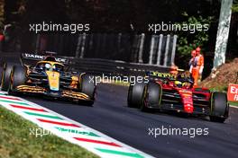 (L to R): Daniel Ricciardo (AUS) McLaren MCL36 and Carlos Sainz Jr (ESP) Ferrari F1-75 battle for position. 11.09.2022. Formula 1 World Championship, Rd 16, Italian Grand Prix, Monza, Italy, Race Day.