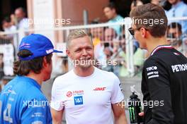 (L to R): Fernando Alonso (ESP) Alpine F1 Team; Kevin Magnussen (DEN) Haas F1 Team; and George Russell (GBR) Mercedes AMG F1, on the drivers parade. 29.05.2022. Formula 1 World Championship, Rd 7, Monaco Grand Prix, Monte Carlo, Monaco, Race Day.
