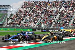 Esteban Ocon (FRA) Alpine F1 Team A522 and Lando Norris (GBR) McLaren MCL36 at the start of the race. 30.10.2022. Formula 1 World Championship, Rd 20, Mexican Grand Prix, Mexico City, Mexico, Race Day.