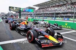 Sergio Perez (MEX) Red Bull Racing RB18 and Pierre Gasly (FRA) AlphaTauri AT03 at pit exit. 30.10.2022. Formula 1 World Championship, Rd 20, Mexican Grand Prix, Mexico City, Mexico, Race Day.