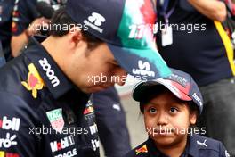 (L to R): Sergio Perez (MEX) Red Bull Racing with a young fan. 27.10.2022. Formula 1 World Championship, Rd 20, Mexican Grand Prix, Mexico City, Mexico, Preparation Day.