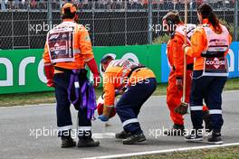 Marshals cover the oil left on the circuit when Max Verstappen (NLD) Red Bull Racing RB18 stopped on track in the first practice session. 02.09.2022. Formula 1 World Championship, Rd 14, Dutch Grand Prix, Zandvoort, Netherlands, Practice Day.
