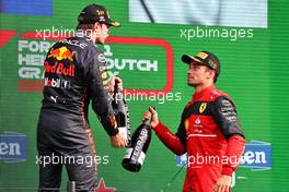 (L to R): race winner Max Verstappen (NLD) Red Bull Racing celebrates on the podium with third placed Charles Leclerc (MON) Ferrari. 04.09.2022. Formula 1 World Championship, Rd 14, Dutch Grand Prix, Zandvoort, Netherlands, Race Day.