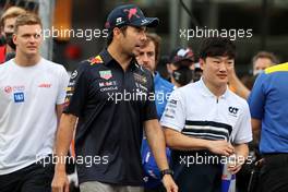 (L to R): Sergio Perez (MEX) Red Bull Racing and Yuki Tsunoda (JPN) AlphaTauri on the drivers parade. 27.03.2022. Formula 1 World Championship, Rd 2, Saudi Arabian Grand Prix, Jeddah, Saudi Arabia, Race Day.