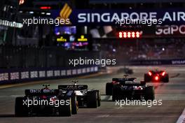 Mick Schumacher (GER) Haas VF-22 and Lando Norris (GBR) McLaren MCL36. 30.09.2022. Formula 1 World Championship, Rd 17, Singapore Grand Prix, Marina Bay Street Circuit, Singapore, Practice Day.