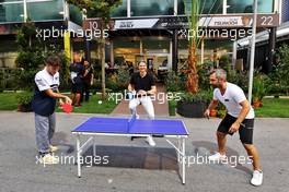 (L to R): Pierre Gasly (FRA) AlphaTauri plays table tennis with Timo Glock (GER) in the paddock. 29.09.2022. Formula 1 World Championship, Rd 17, Singapore Grand Prix, Marina Bay Street Circuit, Singapore, Preparation Day.