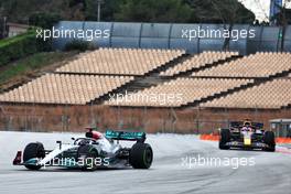 Lewis Hamilton (GBR) Mercedes AMG F1 W13 leads Sergio Perez (MEX) Red Bull Racing RB18. 25.02.2022. Formula One Testing, Day Three, Barcelona, Spain. Friday.
