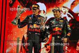 (L to R): Race winner Max Verstappen (NLD) Red Bull Racing and third placed team mate Sergio Perez (MEX) Red Bull Racing celebrate on the podium. 20.11.2022. Formula 1 World Championship, Rd 22, Abu Dhabi Grand Prix, Yas Marina Circuit, Abu Dhabi, Race Day.