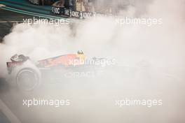 Sergio Perez (MEX) Red Bull Racing RB18 - donuts at the end of the race. 20.11.2022. Formula 1 World Championship, Rd 22, Abu Dhabi Grand Prix, Yas Marina Circuit, Abu Dhabi, Race Day.
