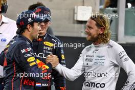 (L to R): Sergio Perez (MEX) Red Bull Racing with Max Verstappen (NLD) Red Bull Racing and Sebastian Vettel (GER) Aston Martin F1 Team in parc ferme. 20.11.2022. Formula 1 World Championship, Rd 22, Abu Dhabi Grand Prix, Yas Marina Circuit, Abu Dhabi, Race Day.