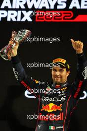 Sergio Perez (MEX) Red Bull Racing celebrates his third position on the podium. 20.11.2022. Formula 1 World Championship, Rd 22, Abu Dhabi Grand Prix, Yas Marina Circuit, Abu Dhabi, Race Day.