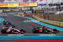 Daniel Ricciardo (AUS) McLaren MCL36 and Mick Schumacher (GER) Haas VF-22. 20.11.2022. Formula 1 World Championship, Rd 22, Abu Dhabi Grand Prix, Yas Marina Circuit, Abu Dhabi, Race Day.