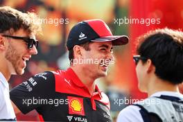 (L to R): Pierre Gasly (FRA) AlphaTauri; Charles Leclerc (MON) Ferrari; and Yuki Tsunoda (JPN) AlphaTauri, on the drivers parade. 20.11.2022. Formula 1 World Championship, Rd 22, Abu Dhabi Grand Prix, Yas Marina Circuit, Abu Dhabi, Race Day.