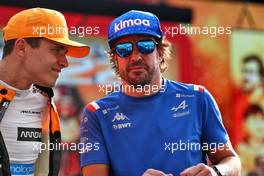 (L to R): Lando Norris (GBR) McLaren with Fernando Alonso (ESP) Alpine F1 Team on the drivers parade. 20.11.2022. Formula 1 World Championship, Rd 22, Abu Dhabi Grand Prix, Yas Marina Circuit, Abu Dhabi, Race Day.