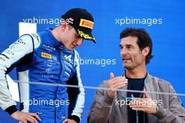 (L to R): Third placed Jack Doohan (AUS) Virtuosi Racing on the podium with Mark Webber (AUS) Channel 4 Presenter. 09.07.2022. FIA Formula 2 Championship, Rd 8, Spielberg, Austria, Saturday.