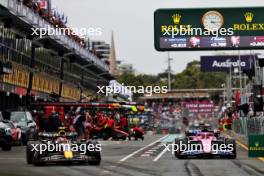 Sergio Perez (MEX) Red Bull Racing RB19 and Esteban Ocon (FRA) Alpine F1 Team leave the pits. 31.03.2023. Formula 1 World Championship, Rd 3, Australian Grand Prix, Albert Park, Melbourne, Australia, Practice Day.