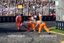 Marshals sweep clear the gravel left by Alexander Albon (THA) Williams Racing that brought out the red flag. 02.04.2023. Formula 1 World Championship, Rd 3, Australian Grand Prix, Albert Park, Melbourne, Australia, Race Day.