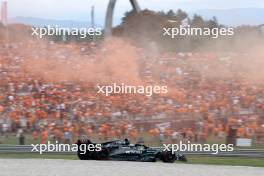 Lewis Hamilton (GBR) Mercedes AMG F1 W14 passes fans in the grandstand with flares being set off. 30.06.2023. Formula 1 World Championship, Rd 10, Austrian Grand Prix, Spielberg, Austria, Qualifying Day.