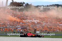 Charles Leclerc (MON) Ferrari SF-23 passes fans in the grandstand with flares being set off. 30.06.2023. Formula 1 World Championship, Rd 10, Austrian Grand Prix, Spielberg, Austria, Qualifying Day.