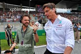 Toto Wolff (GER) Mercedes AMG F1 Shareholder and Executive Director with Chris Medland (GBR) Journalist on the grid. 02.07.2023. Formula 1 World Championship, Rd 10, Austrian Grand Prix, Spielberg, Austria, Race Day.