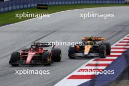 Carlos Sainz Jr (ESP) Ferrari SF-23 and Lando Norris (GBR) McLaren MCL60 battle for position. 02.07.2023. Formula 1 World Championship, Rd 10, Austrian Grand Prix, Spielberg, Austria, Race Day.