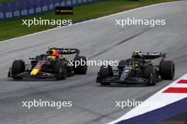 (L to R): Sergio Perez (MEX) Red Bull Racing RB19 and Lewis Hamilton (GBR) Mercedes AMG F1 W14 battle for position. 02.07.2023. Formula 1 World Championship, Rd 10, Austrian Grand Prix, Spielberg, Austria, Race Day.
