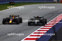 (L to R): Sergio Perez (MEX) Red Bull Racing RB19 and Lewis Hamilton (GBR) Mercedes AMG F1 W14 battle for position. 02.07.2023. Formula 1 World Championship, Rd 10, Austrian Grand Prix, Spielberg, Austria, Race Day.