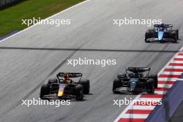 Sergio Perez (MEX) Red Bull Racing RB19 and George Russell (GBR) Mercedes AMG F1 W14 battle for position. 02.07.2023. Formula 1 World Championship, Rd 10, Austrian Grand Prix, Spielberg, Austria, Race Day.