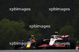 Nico Hulkenberg (GER) Haas VF-23 and Sergio Perez (MEX) Red Bull Racing RB19 battle for position. 01.07.2023. Formula 1 World Championship, Rd 10, Austrian Grand Prix, Spielberg, Austria, Sprint Day.