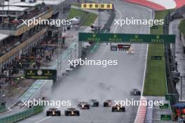 (L to R): Sergio Perez (MEX) Red Bull Racing RB19 and Max Verstappen (NLD) Red Bull Racing RB19 battle for the lead at the start of the race. 01.07.2023. Formula 1 World Championship, Rd 10, Austrian Grand Prix, Spielberg, Austria, Sprint Day.
