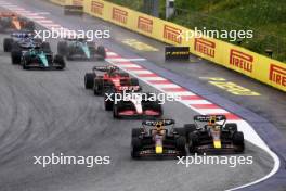 (L to R): Max Verstappen (NLD) Red Bull Racing RB19 and team mate Sergio Perez (MEX) Red Bull Racing RB19 battle for the lead at the start of the race. 01.07.2023. Formula 1 World Championship, Rd 10, Austrian Grand Prix, Spielberg, Austria, Sprint Day.