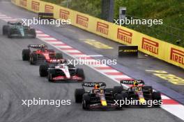 (L to R): Max Verstappen (NLD) Red Bull Racing RB19 and team mate Sergio Perez (MEX) Red Bull Racing RB19 battle for the lead at the start of the race. 01.07.2023. Formula 1 World Championship, Rd 10, Austrian Grand Prix, Spielberg, Austria, Sprint Day.
