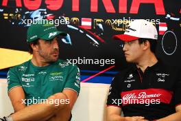 (L to R): Fernando Alonso (ESP) Aston Martin F1 Team and Zhou Guanyu (CHN) Alfa Romeo F1 Team in the FIA Press Conference. 29.06.2023. Formula 1 World Championship, Rd 10, Austrian Grand Prix, Spielberg, Austria, Preparation Day.