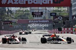 (L to R): Charles Leclerc (MON) Ferrari SF-23 and Sergio Perez (MEX) Red Bull Racing RB19 battle for position. 30.04.2023. Formula 1 World Championship, Rd 4, Azerbaijan Grand Prix, Baku Street Circuit, Azerbaijan, Race Day.