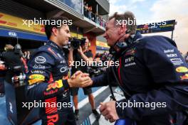 (L to R): Sergio Perez (MEX) Red Bull Racing celebrates his second position with Christian Horner (GBR) Red Bull Racing Team Principal in parc ferme. 30.07.2023. Formula 1 World Championship, Rd 13, Belgian Grand Prix, Spa Francorchamps, Belgium, Race Day.