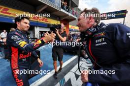 (L to R): Sergio Perez (MEX) Red Bull Racing celebrates his second position with Christian Horner (GBR) Red Bull Racing Team Principal in parc ferme. 30.07.2023. Formula 1 World Championship, Rd 13, Belgian Grand Prix, Spa Francorchamps, Belgium, Race Day.