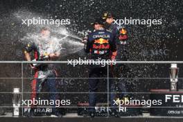 Race winner Max Verstappen (NLD) Red Bull Racing celebrates with Sergio Perez (MEX) Red Bull Racing and Greg Reeson (GBR) Red Bull Racing Tyre Technician on the podium. 30.07.2023. Formula 1 World Championship, Rd 13, Belgian Grand Prix, Spa Francorchamps, Belgium, Race Day.