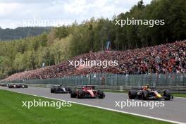 Charles Leclerc (MON) Ferrari SF-23 and Sergio Perez (MEX) Red Bull Racing RB19 battle at the start of the race. 30.07.2023. Formula 1 World Championship, Rd 13, Belgian Grand Prix, Spa Francorchamps, Belgium, Race Day.