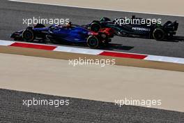 Alexander Albon (THA) Williams Racing FW45 and Lewis Hamilton (GBR) Mercedes AMG F1 W14. 03.03.2023. Formula 1 World Championship, Rd 1, Bahrain Grand Prix, Sakhir, Bahrain, Practice Day