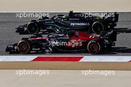 Valtteri Bottas (FIN) Alfa Romeo F1 Team C43 and Lewis Hamilton (GBR) Mercedes AMG F1 W14. 03.03.2023. Formula 1 World Championship, Rd 1, Bahrain Grand Prix, Sakhir, Bahrain, Practice Day