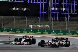 Nico Hulkenberg (GER) Haas VF-23 and Zhou Guanyu (CHN) Alfa Romeo F1 Team C43 battle for position. 05.03.2023. Formula 1 World Championship, Rd 1, Bahrain Grand Prix, Sakhir, Bahrain, Race Day.