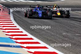 Alexander Albon (THA) Williams Racing FW45 and Sergio Perez (MEX) Red Bull Racing RB19. 04.03.2023. Formula 1 World Championship, Rd 1, Bahrain Grand Prix, Sakhir, Bahrain, Qualifying Day.