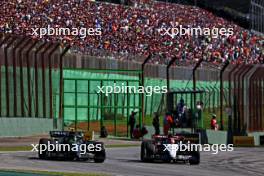 (L to R): Lewis Hamilton (GBR) Mercedes AMG F1 W14 and Yuki Tsunoda (JPN) AlphaTauri AT04 battle for position. 04.11.2023. Formula 1 World Championship, Rd 21, Brazilian Grand Prix, Sao Paulo, Brazil, Sprint Day.